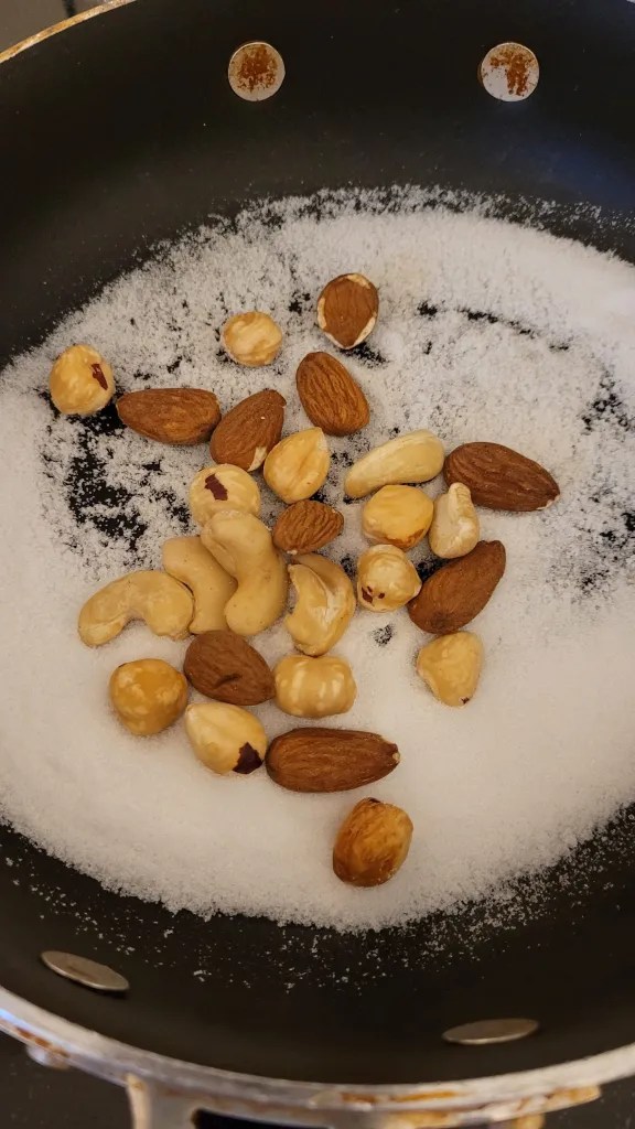 mixed nuts in a pan with sugar