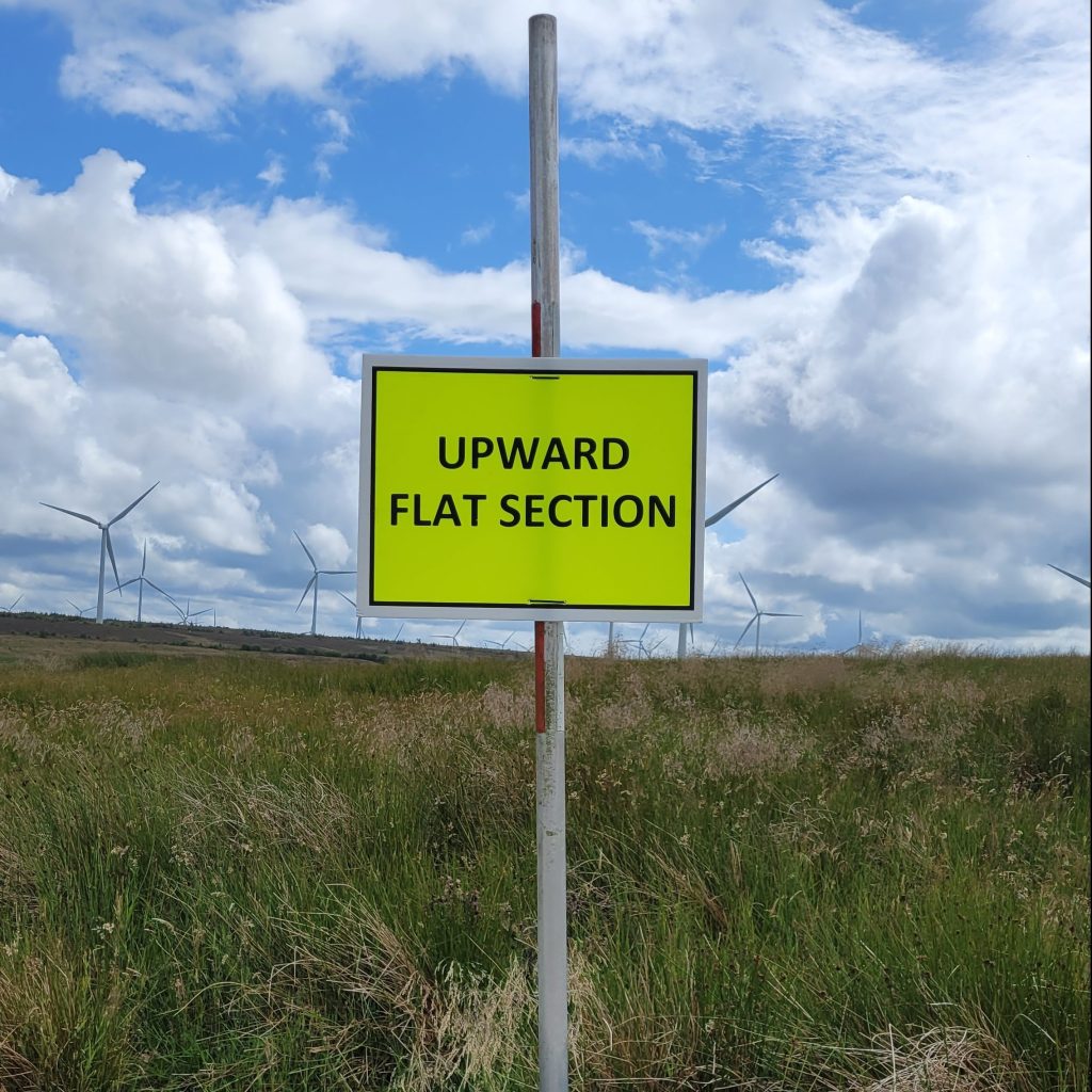 a sign reading "upward flat section" during an ultramarathon