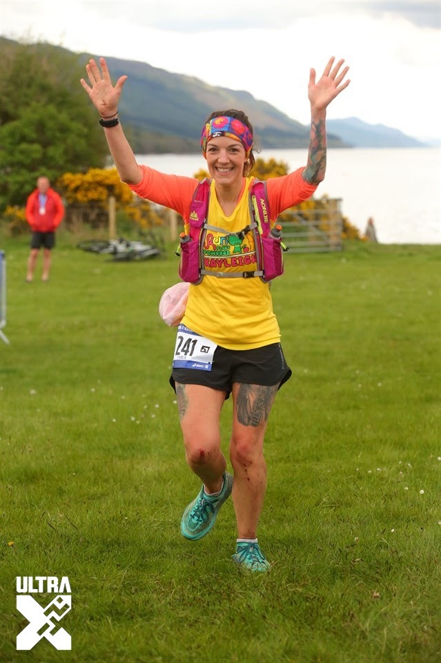 Kayleigh at the finish line at Ultra X with her hands in the air.