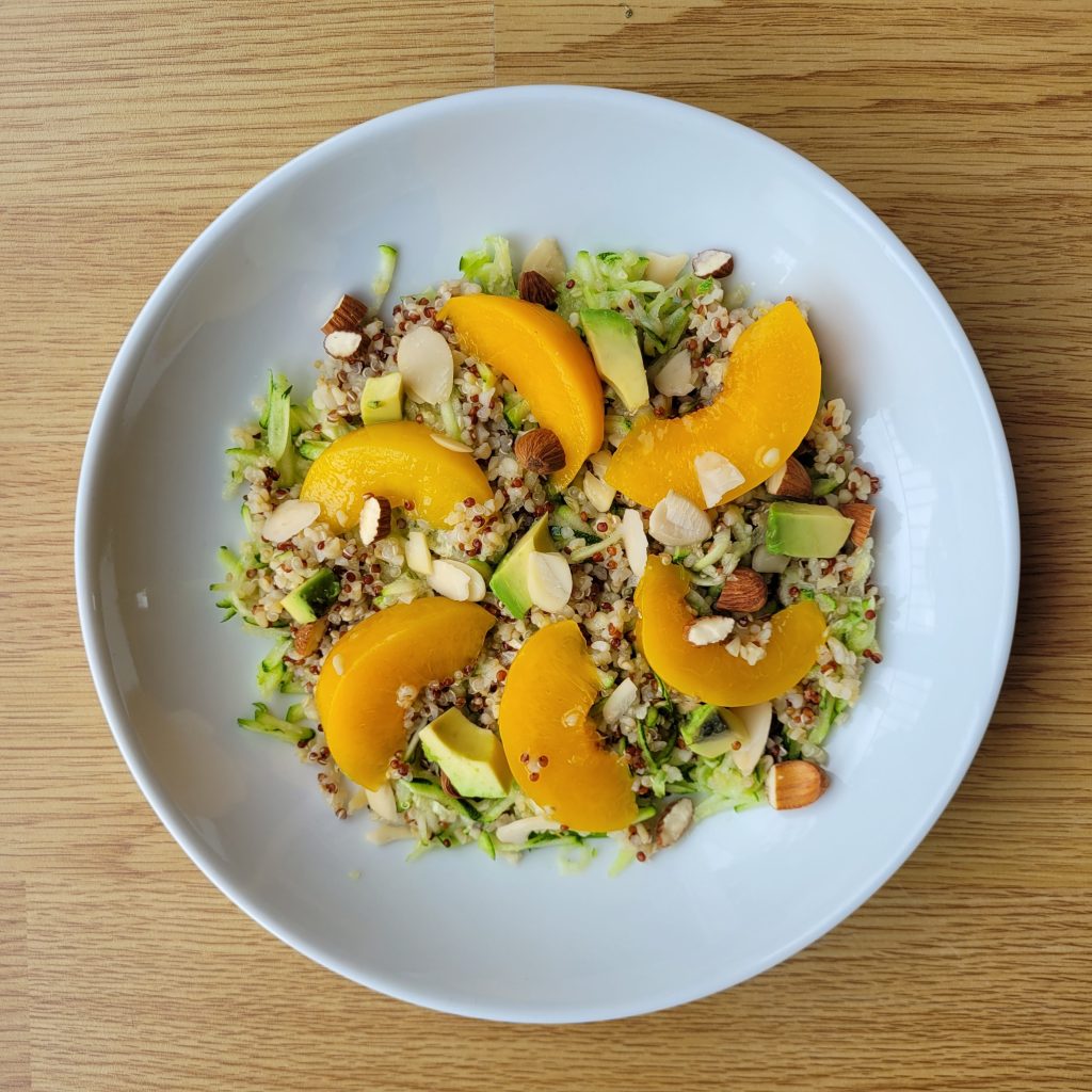 A white bowl with a peach salad
